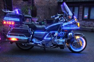 The image is of a Honda Goldwing with fairy lights all around it.